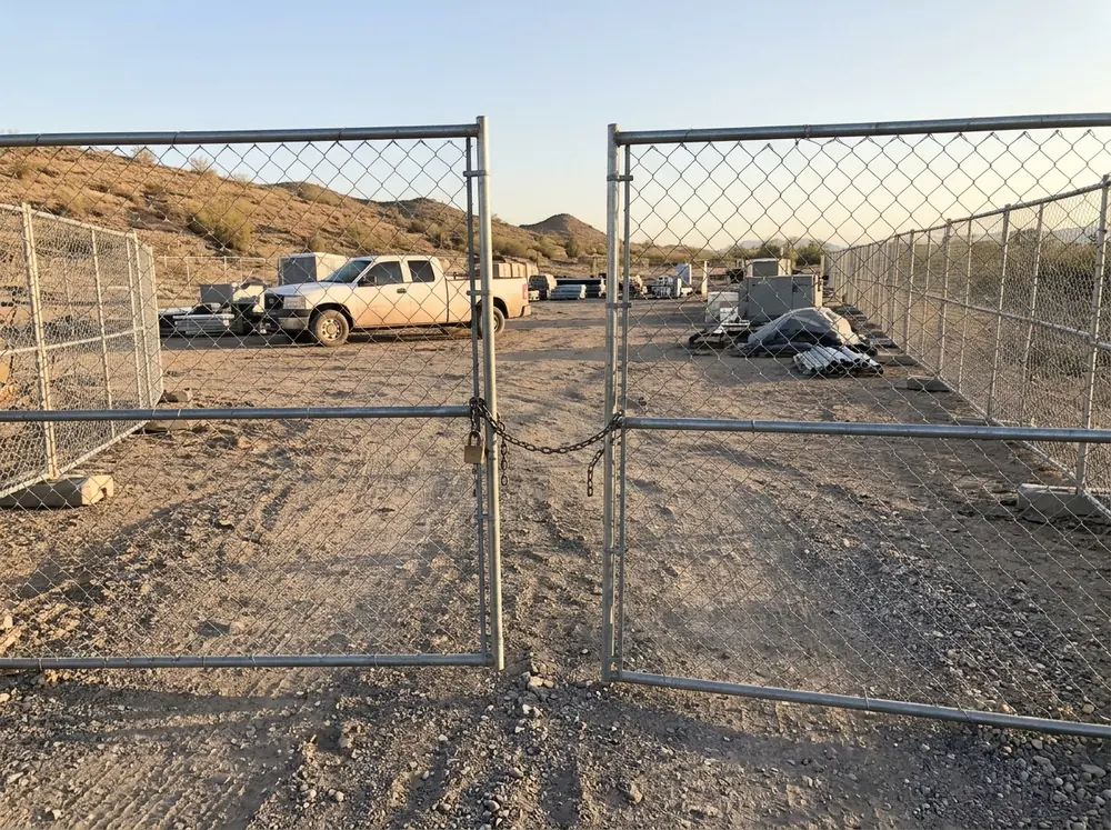 A double swing gate in a temporary chain link fence at a job site entrance